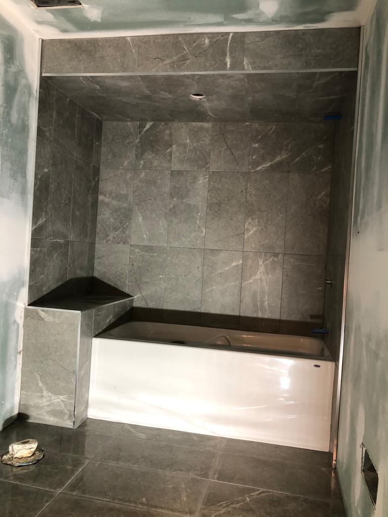 basement renovation ideas - custom bathroom with gray wall marble tiles - toronto basement renovation