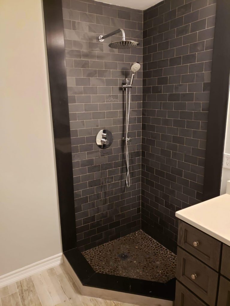basement bathroom with walk in shower and brick decor wall - basement ideas